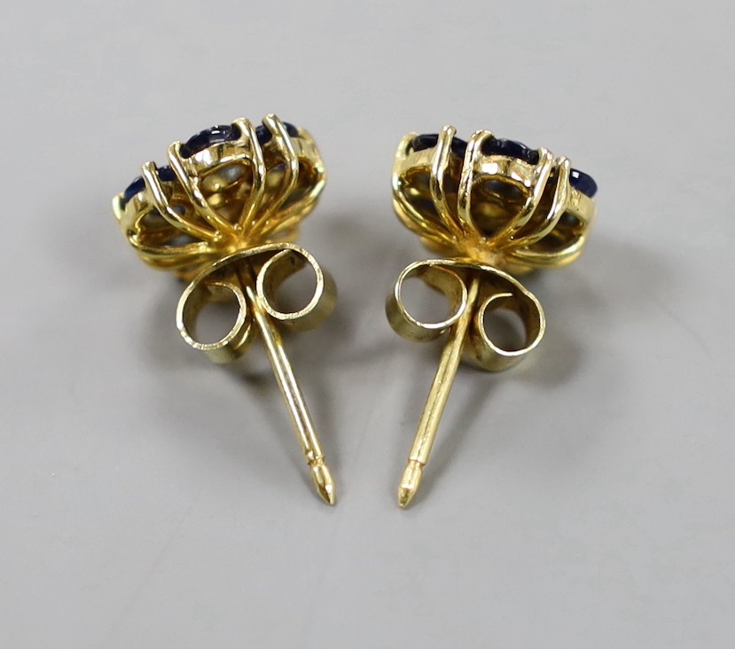 A pair of yellow metal, sapphire and diamond set flower head cluster earrings, 9mm, gross weight 3.7 grams.
